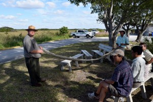 Park Ranger Chris Littlejohn unfolds the skin of a recently caught python with the help of visitor Tom Southern at the Everglades National Park on Nov. 19, 2014.
